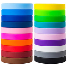 Two stacks of silicone wristbands in various colors, including light blue, royal blue, navy, pink, magenta, orange, red, brown, yellow, green, teal, lavender, purple, white, gray, and black, arranged side by side on a white background.