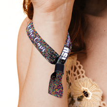 Multicolored Custom Fabric Wristbands with text worn around a neck, close-up on a white background