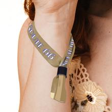 Person wearing a Custom Fabric Wristbands with 'ROUTE 66' branding on a plain background