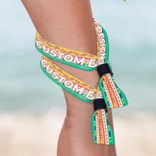 Colorful custom-designed Custom Fabric Wristbands on a person's wrist with a blurred background