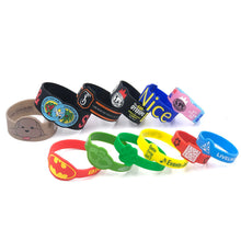 A group of colorful silicone wristbands arranged on a plain white background. The wristbands feature various designs, including cartoon dog graphics, sports team logos, QR codes, and text such as 'Nice' and 'LIVELAND'.