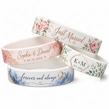 Four personalized silicone wristbands with wedding-themed designs, including floral, watercolor, and monogram patterns, arranged on a clean white background.