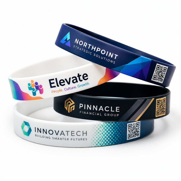 Four custom printed silicone wristbands stacked on a white background, each featuring a different corporate design with logos, text, and QR codes.