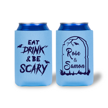 Two blue can coolers with Halloween-themed designs on a white background