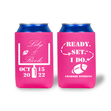 Two pink can coolers with wedding-themed designs and text on a white background